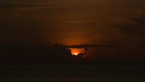 Time-lapse of sun rising over sea Stock Footage 117751517