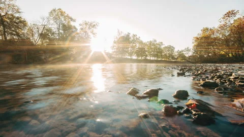 Time-lapse of the sun rising over a secluded misty river Stock Footage 258878035