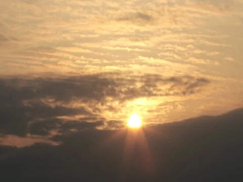 Time lapse of sun rising through dark gray clouds : 4K footage Stock Footage 75248298