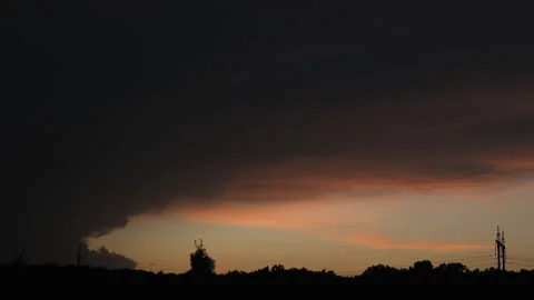 Time lapse of sun setting behind the forest and power line on a background. the Stock Footage 156038159
