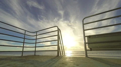Time lapse of sun setting over Pacific Ocean from atop a Lifeguard Tower in 4k 스톡 동영상 58741983