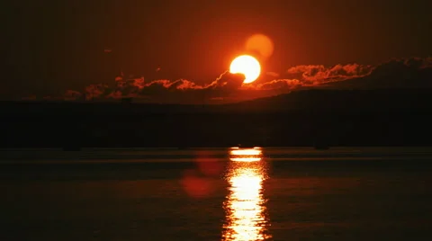 Time Lapse of Sun Setting over River and Bridge. Stock Footage