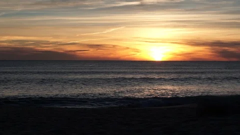 Time lapse of sun setting over sea, on beach in Algarve, Portugal Stock Footage 103187068