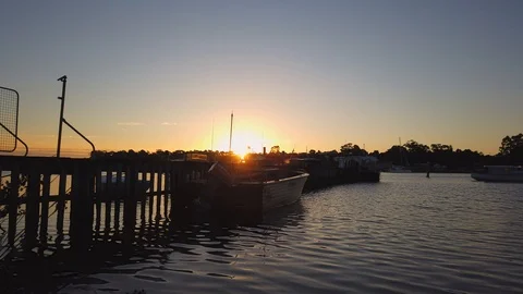 Time-lapse of sun setting over small pier in Strahan Tasmania Stock Footage 106929183