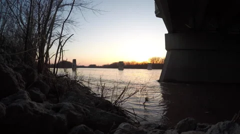 Time Lapse of sun setting with river in foreground Stock Footage 49166655