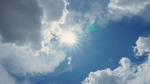 Time lapse of sun shining in blue sky with clouds movement in the day Stock Footage 134746320