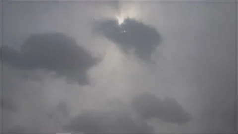 Time lapse: the sun shining through thik dense stormy snowing clouds Stock Footage