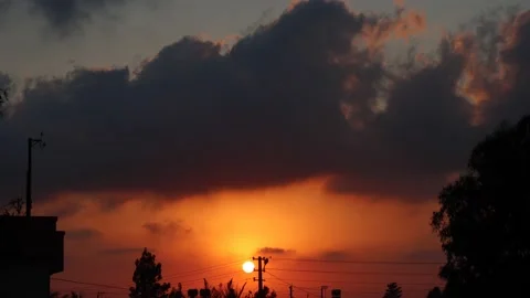 Time Lapse of the sun sunset from behind downtown Stock Footage 136440935