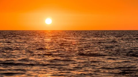 Time lapse - Sun at sunset going down at the ocean Stock Footage 99370094