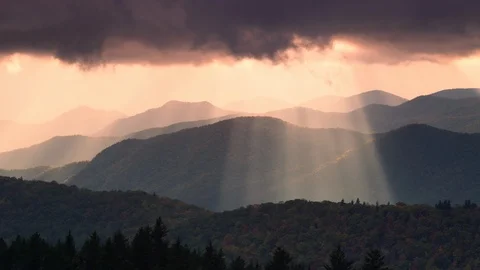 Time-lapse of sunbeams moving across the mountain ranges at sunset Stock Footage 103398467