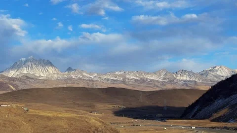 Time-lapse of sunlight and clouds over Zheduo Mountain, Ganzi, Sichuan, Chin Stock Footage 328782239
