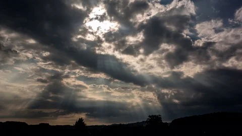 Time lapse of sunlight passing through moving clouds Stock Footage 77815443