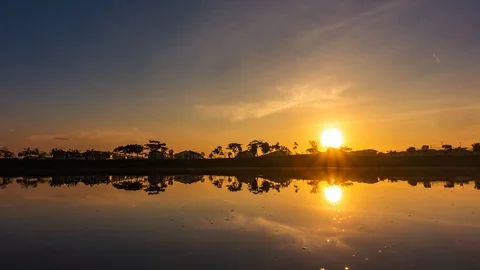 Time-lapse of sunrise and reflections on the lake at Hillpark, Puncak Alam Stock Footage 129865070