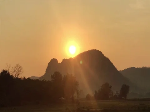 Time Lapse Sunrise behind a big mountain, beautiful orange light. Stock Footage