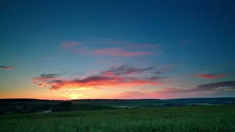 Time-lapse of sunrise, clouds in sky and farmland at dawn Stock Footage 147197118