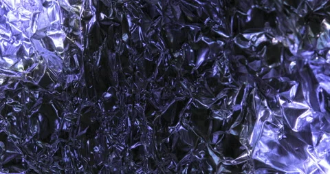 Time lapse sunrise drop shadow on a crumpled foil Stock-Footage 130358696