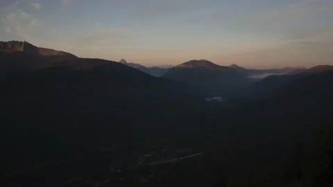 Time lapse of sunrise over small mountain valley town Stock Footage 141227378