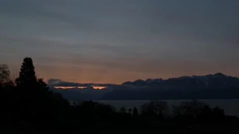 Time lapse of sunrise over trees, clouds and lake. Lausanne, Switzerland. Stock Footage 145729077