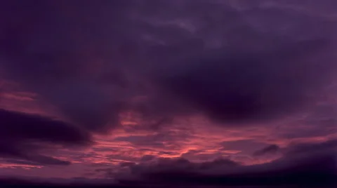 Time-lapse sunrise with purple clouds changing to rosy pink Stock Footage 59533706