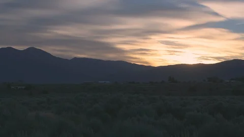 Time lapse sunrise Ranchos de Taos valley and mountain landscape clouds moving Stock Footage 129173595