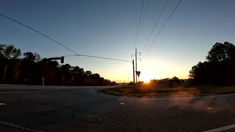 Time-lapse Sunrise speeding traffic golden hour and smoke from exhaust early  Stock Footage 179208850