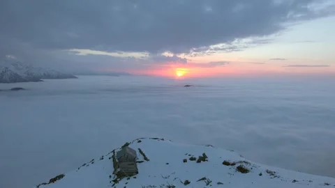 Time lapse sunset above sea of clouds over snowy high altitude mountains Stock Footage 339373145