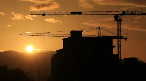 Time lapse sunset and silhouette crane working in construction site Stock Footage 52025792