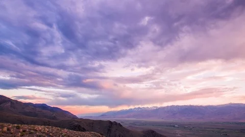 Time Lapse - Sunset with Beautiful Cloudscape and Snow-capped Mountain - 4K Stock Footage 77565751