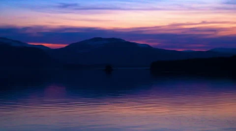 Time lapse of a sunset behind the silhouette of a mountain ridge in the Inside Stock Footage 52217452