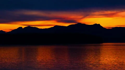 Time lapse of the sunset behind the silhouette of a mountain ridge in the Inside Stock Footage 52217504