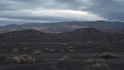 Time lapse of sunset clouds above volcanic hills and mountains in Death Valley Stock Footage 147516133