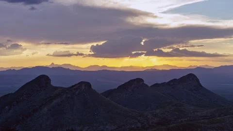 Time lapse of sunset clouds above four mountain peaks Stock Footage 325229869