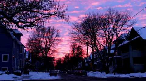 Time lapse: Sunset clouds over a snowy street with traffic and holiday lights Stock Footage 34334555
