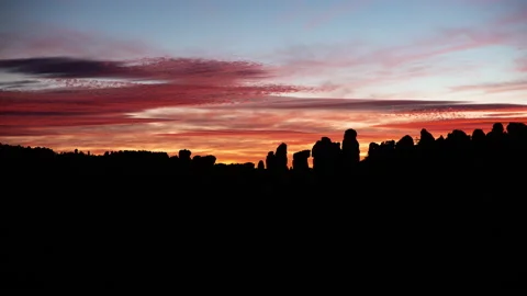 Time lapse of Sunset clouds silhouetting Chiricahua national monument pinnacles Stock Footage 228975856