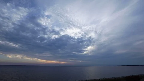 Time Lapse of Sunset with Cloudy Skies Over Calm River Video stock 119001463