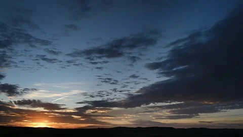 Time lapse of sunset with colorful sky and multi-colored clouds with distant Stock Footage 306541736