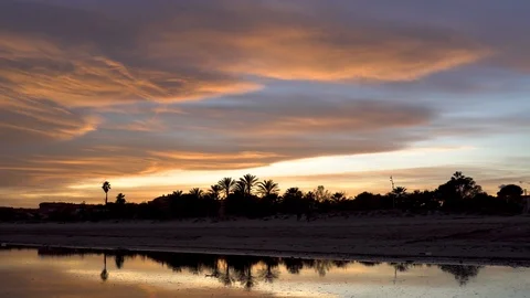 Time Lapse, sunset with diffuse clouds waving over the sky while two Stock Footage 121422287