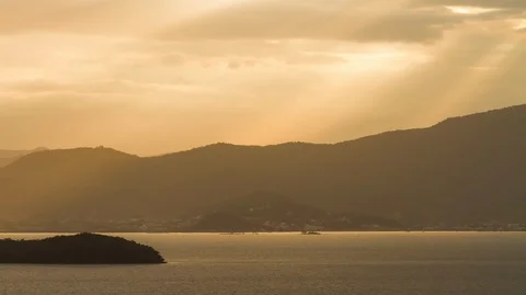 Time lapse of a sunset with golden light over the sea. 2K Stock Footage 88975208