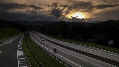 TIME LAPSE SUNSET ON HIGHWAY WITH CAR TRAVEL FROM TOP VIEW 4KUHD 29.97 HQ Stock Footage