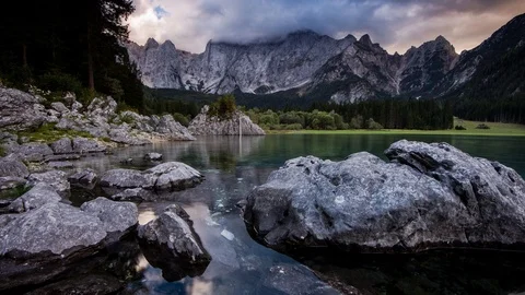 Time Lapse - Sunset at the Lago di Fusine with colourful clouds Stock Footage 99364337