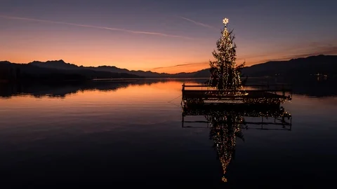 Time Lapse - Sunset at a Lake with shining lights on a Christmas Tree Stock Footage 99368435