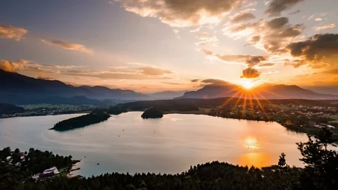Time lapse - Sunset at the lake with a view to the mountain, boats, water sport Stock Footage 99359307