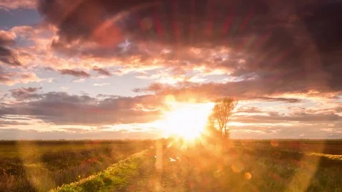 Time Lapse of Sunset With Lens Flare Behind A Country Road Stock Footage 106157378