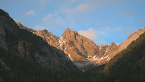 Time-lapse of sunset in mountain with moving clouds Stock Footage 310640476