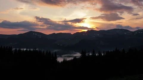 Time lapse of sunset in the mountains in cloudy summer day Stock Footage 243510566