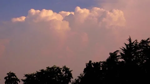 Time lapse of sunset in the orange clouds that develop in spectacular cumulus Stock Footage 138924419