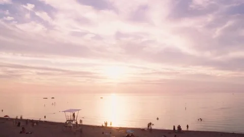 Time-lapse of sunset over beach at lake huron with people in water and boats Stock Footage 82830278