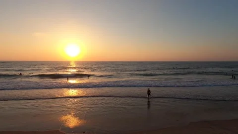 Time lapse sunset over the beach. People walking swimming and rowing kayaking Stock Footage 134203247