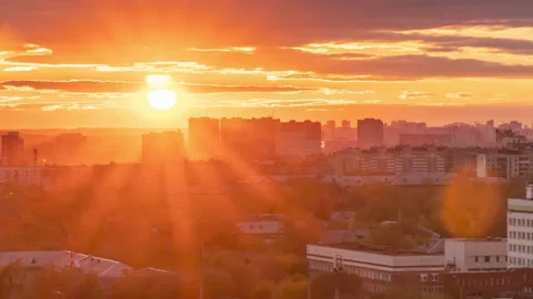 Time lapse of a sunset over a city with small clouds in the sky Stock Footage 162180310