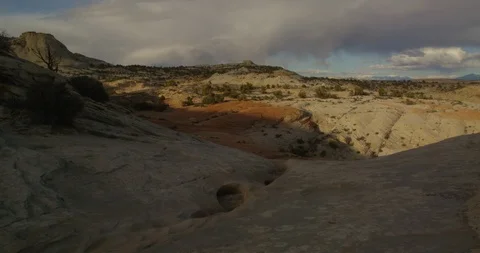 Time-Lapse of sunset over convoluted gully eroded into colorful stone, Utah Stock Footage 124463173